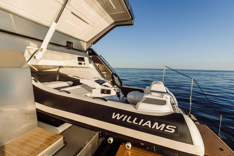 Slide: The Image of 2026 Cranchi Sessantasette 67 Corsa yacht with Williams tender on deck, ocean view. - 25