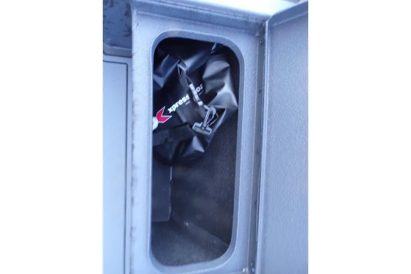 Slide: The Image of Storage compartment of 2026 Xpress X18DB boat with branded bag inside. - 10
