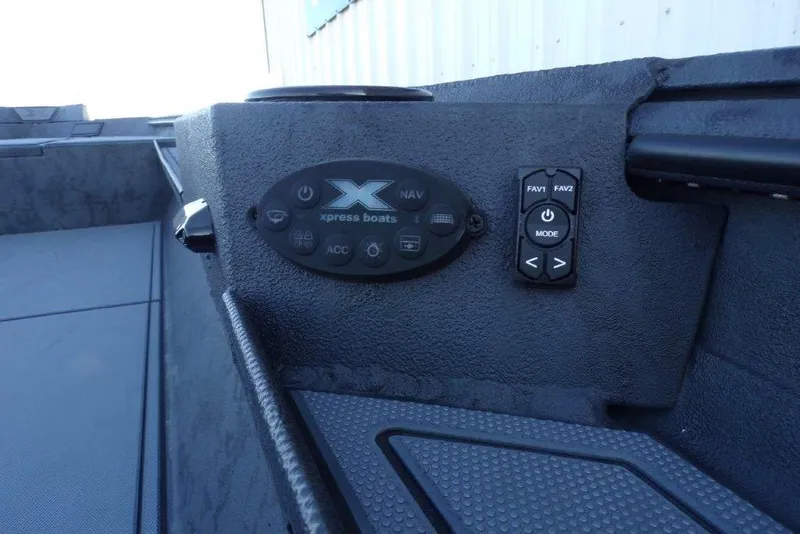 Slide: The Image of Control panel of 2026 Xpress X18DB boat with navigation and mode buttons. - 11