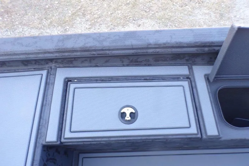 Slide: The Image of 2026 Xpress X18DB boat storage compartment with lock, featuring sleek design. - 15