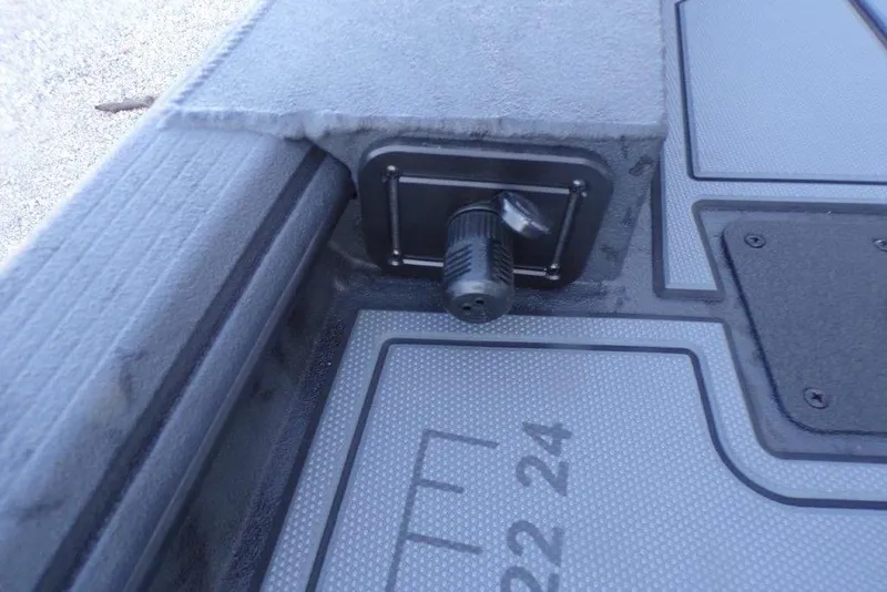 Slide: The Image of 2026 Xpress X18DB boat interior with textured flooring and a mounted socket. - 16