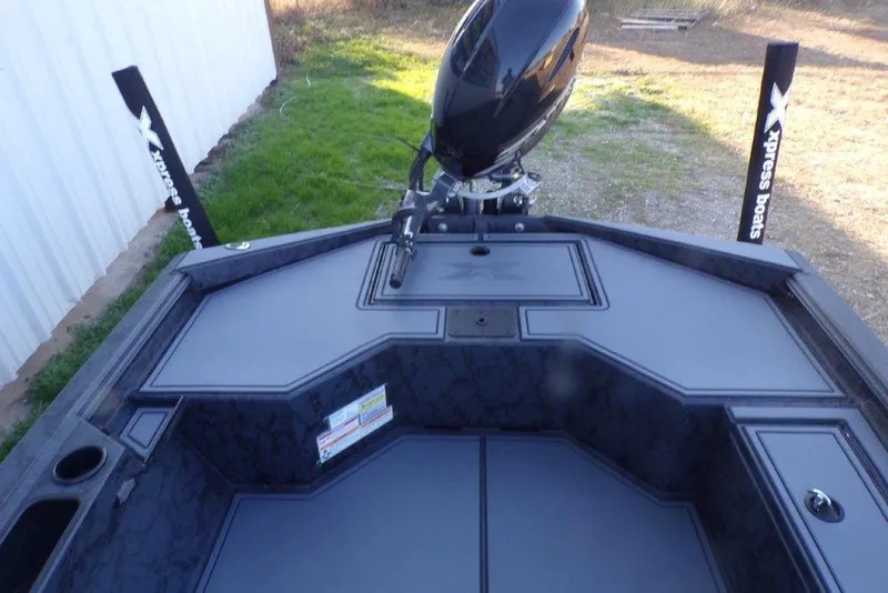 Slide: The Image of 2026 Xpress X18DB boat interior with motor, featuring sleek design and storage compartments. - 2