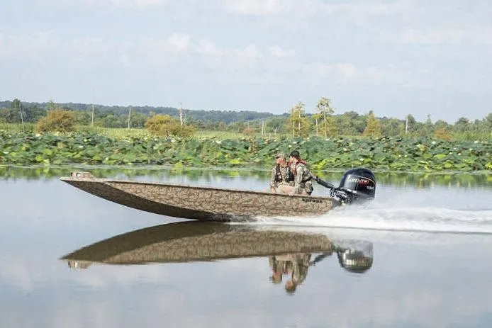Slide: The Image of Manufacturer Provided Image: 2026 Xpress X18DB boat speeding on a calm lake with lush greenery in the background. - 25