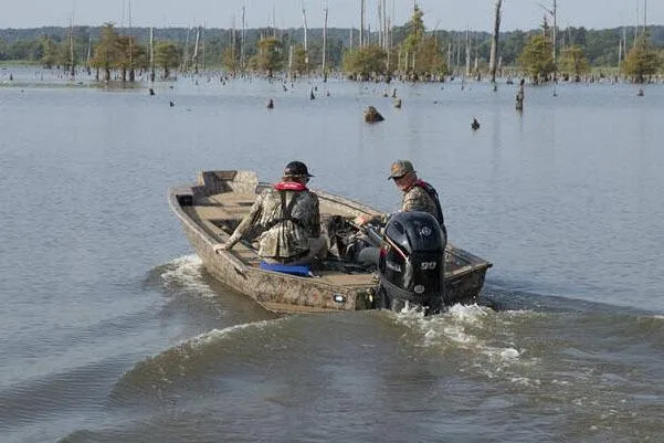 Slide: The Image of Manufacturer Provided Image: Two people in a 2026 Xpress X18DB boat navigating a calm lake. - 26
