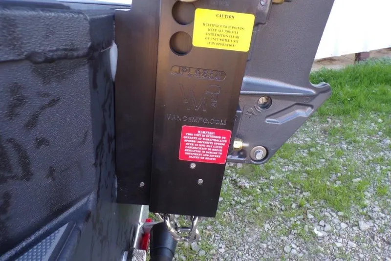 Slide: The Image of Close-up of Xpress X18DB 2026 trailer hitch with caution labels. - 3
