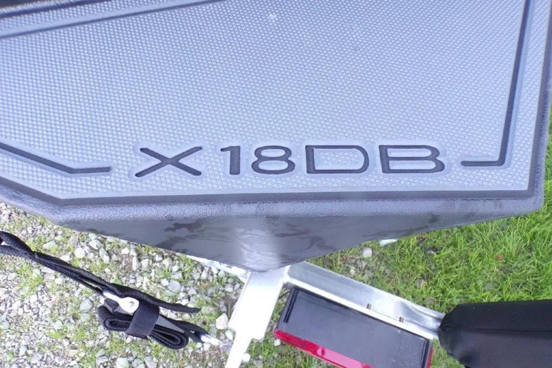 Slide: The Image of 2026 Xpress X18DB boat detail on textured surface, outdoor setting. - 9