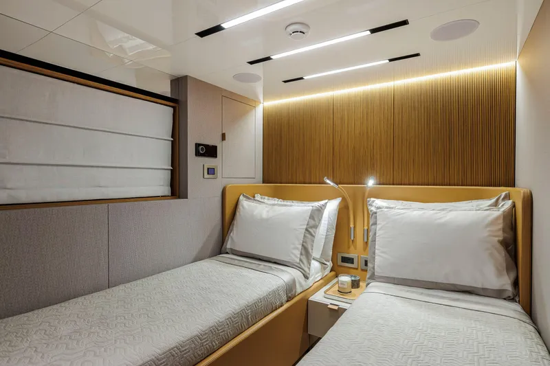 Slide: The Image of Luxurious twin cabin interior of 2026 Cranchi Sessantadue 62 yacht, featuring modern design and ambient lighting. - 16