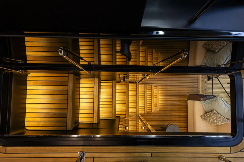 Slide: The Image of Luxurious interior staircase of 2026 Cranchi Sessantadue 62 yacht, featuring elegant wood paneling. - 18