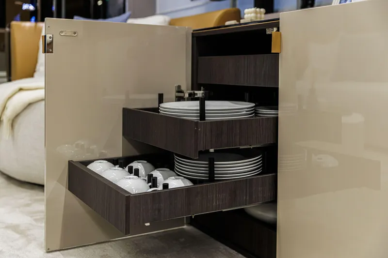 Slide: The Image of Luxury yacht Cranchi Sessantadue 62 interior with open cabinet displaying plates and cups. - 22