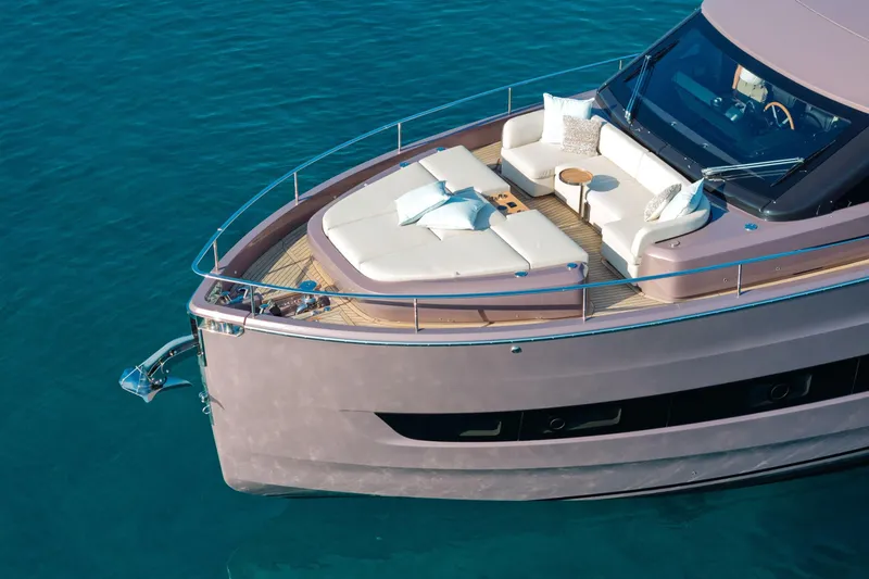 Slide: The Image of Luxurious 2026 Cranchi Sessantadue 62 yacht with elegant deck seating on tranquil water. - 31