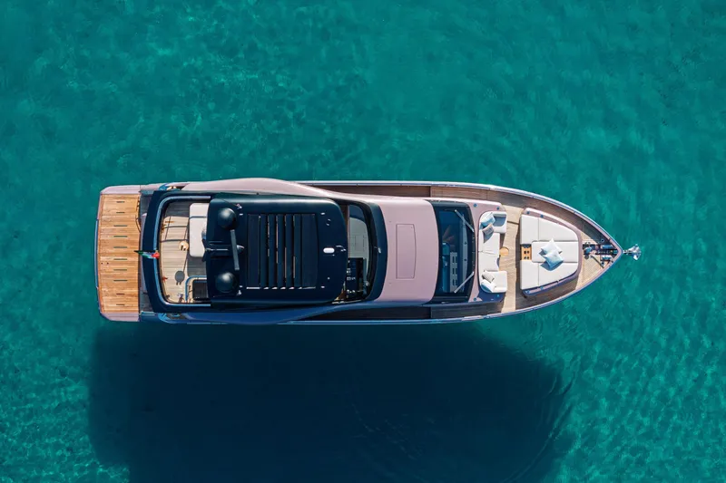 Slide: The Image of Aerial view of 2026 Cranchi Sessantadue 62 yacht on clear turquoise water. - 34
