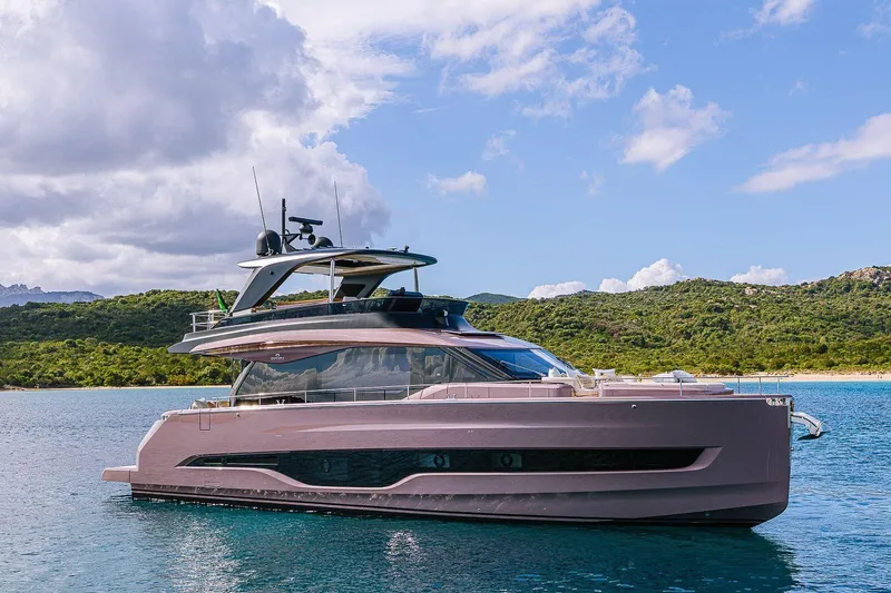 Slide: The Image of 2026 Cranchi Sessantadue 62 yacht on serene water with lush green hills. - 40