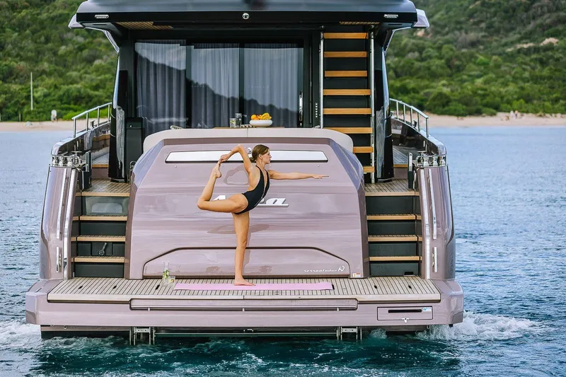Slide: The Image of Woman practicing yoga on Cranchi Sessantadue 62 yacht, 2026 model, in serene waters. - 43