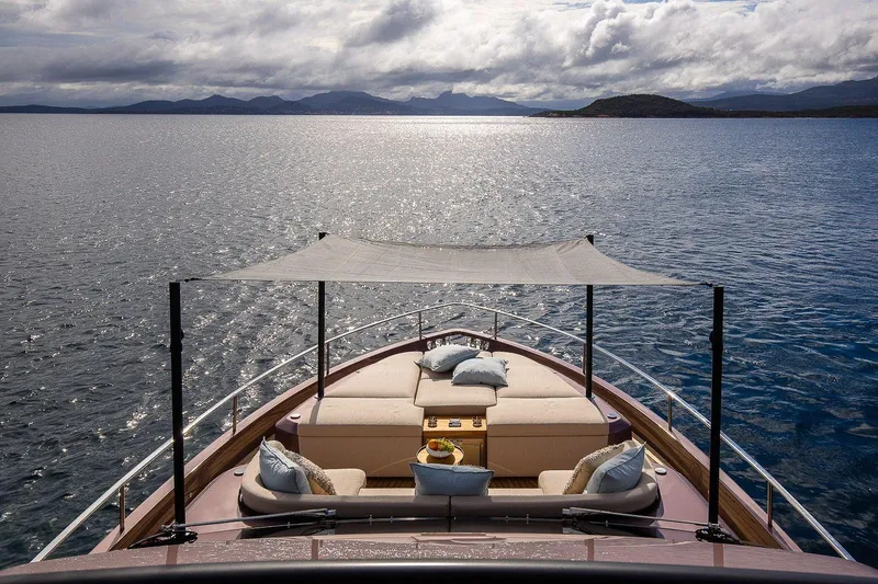 Slide: The Image of Luxurious 2026 Cranchi Sessantadue 62 yacht with elegant deck seating and scenic ocean view. - 47