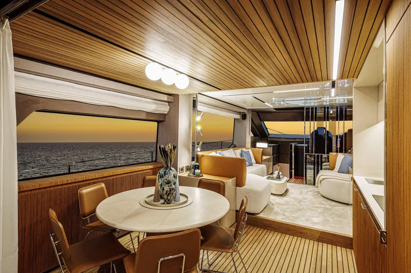 Slide: The Image of Luxurious interior of 2026 Cranchi Sessantadue 62 yacht at sunset, featuring elegant seating and dining area. - 7