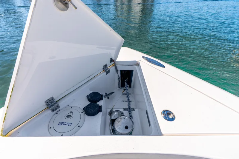 Slide: The Image of Open anchor compartment on 2015 Intrepid 475 Panacea boat, with visible chain and winch. - 12