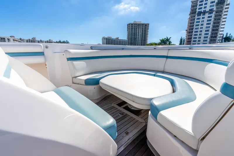 Slide: The Image of 2015 Intrepid 475 Panacea boat with spacious seating area and cityscape background. - 13