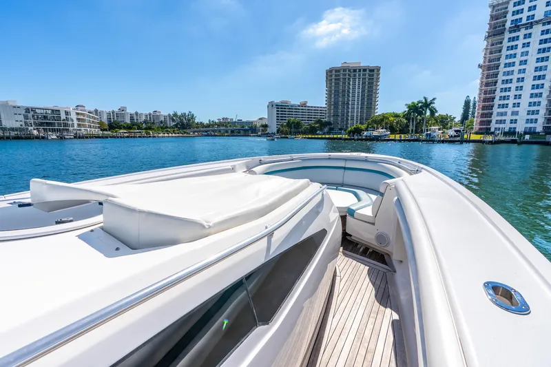 Slide: The Image of 2015 Intrepid 475 Panacea yacht on calm water, cityscape in background. - 15