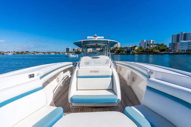 Slide: The Image of 2015 Intrepid 475 Panacea boat on water, clear blue sky, luxury seating. - 16