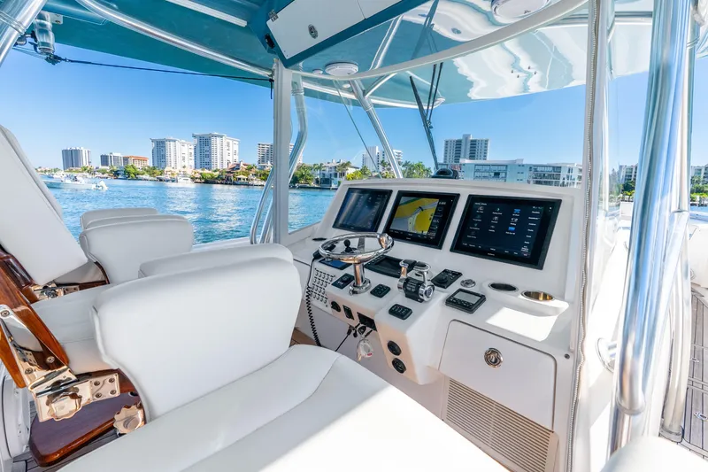 Slide: The Image of 2015 Intrepid 475 Panacea helm with modern controls and waterfront city view. - 20