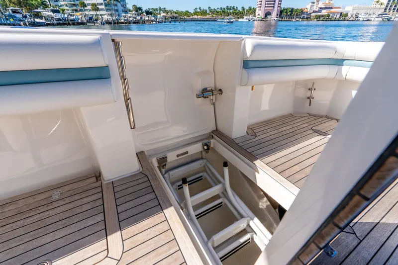 Slide: The Image of 2015 Intrepid 475 Panacea boat interior with open hatch and wooden deck. - 27