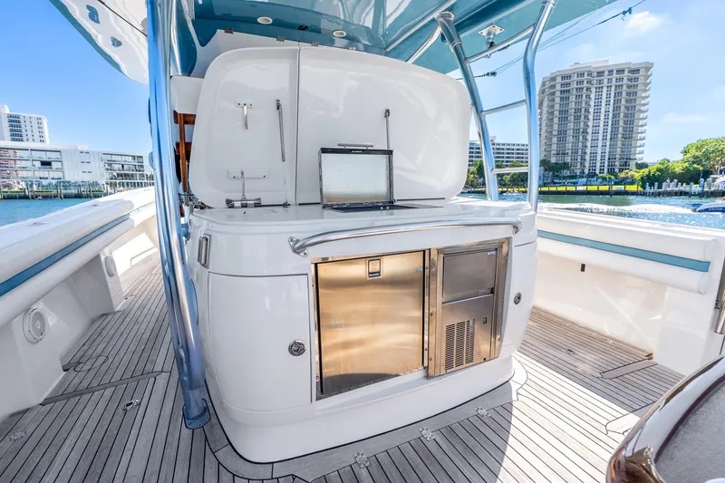Slide: The Image of 2015 Intrepid 475 Panacea yacht interior with sleek kitchen area and waterfront view. - 28