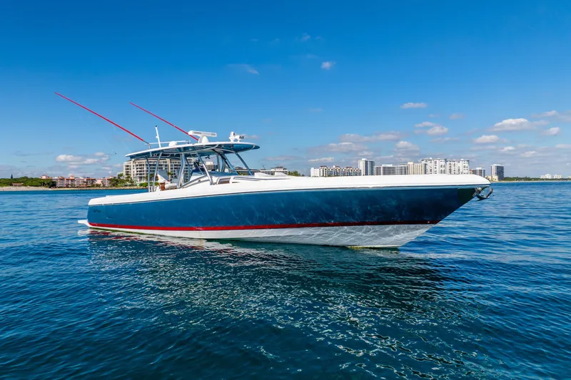 Slide: The Image of 2015 Intrepid 475 Panacea boat on calm water with cityscape background. - 5