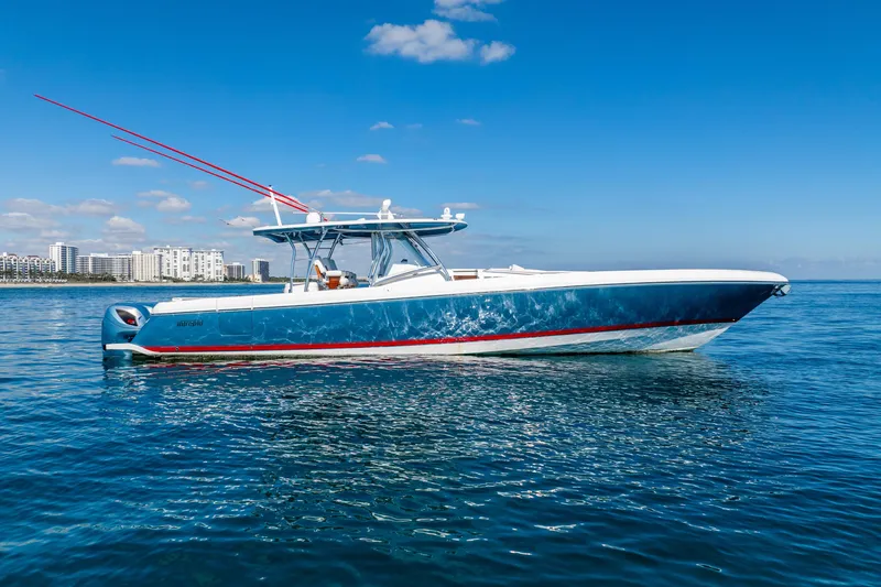 Slide: The Image of 2015 Intrepid 475 Panacea boat on calm ocean with city skyline in background. - 6
