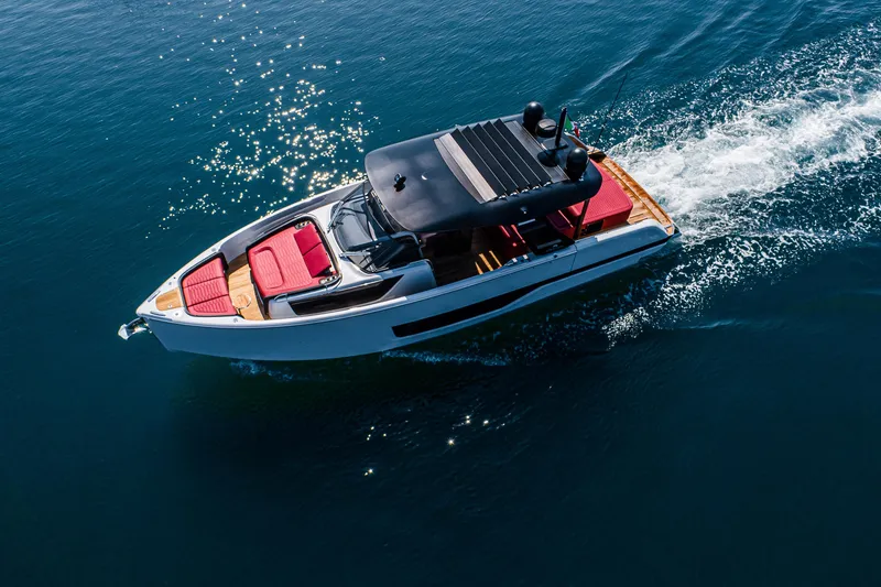 Slide: The Image of 2026 Cranchi A46 Luxury Tender cruising on clear blue water, featuring sleek design and red seating. - 19