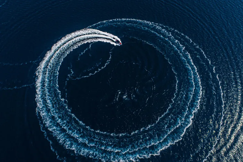 Slide: The Image of Aerial view of Cranchi A46 Luxury Tender creating circular wake in deep blue water. - 24