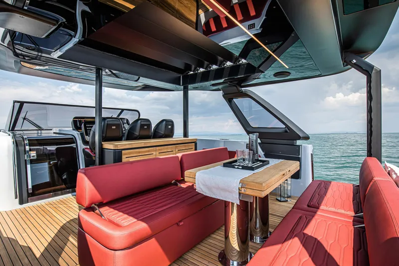 Slide: The Image of Luxurious interior of 2026 Cranchi A46 Luxury Tender with red seating and ocean view. - 28