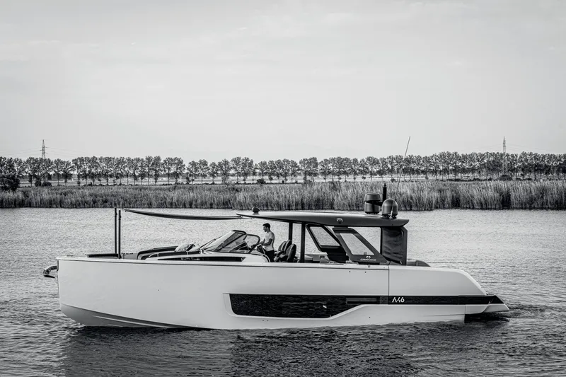 Slide: The Image of 2026 Cranchi A46 Luxury Tender cruising on a serene river with a tree-lined background. - 44