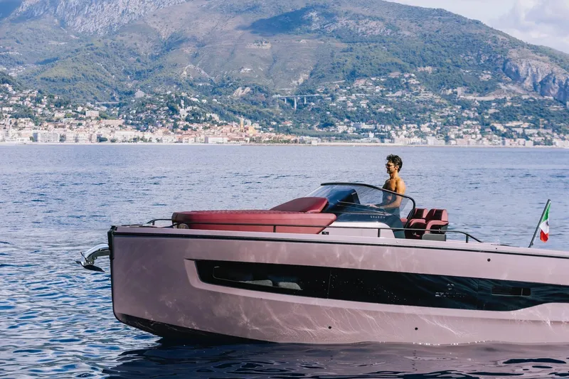 Slide: The Image of 2026 Cranchi A32 Luxury Tender cruising on scenic waters with mountainous backdrop. - 12