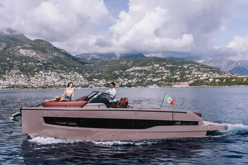 Slide: The Image of 2026 Cranchi A32 Luxury Tender cruising on scenic waters with mountainous backdrop. - 26