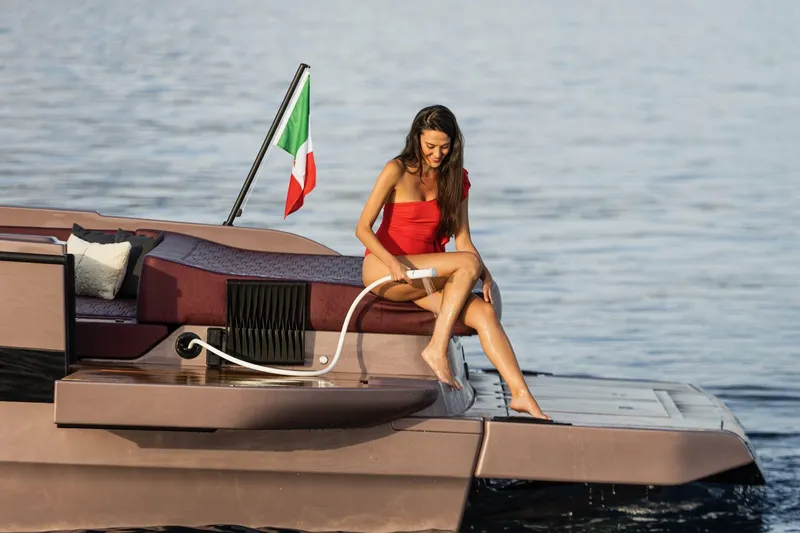 Slide: The Image of Woman relaxing on 2026 Cranchi A32 Luxury Tender yacht, Italian flag, serene waters. - 34