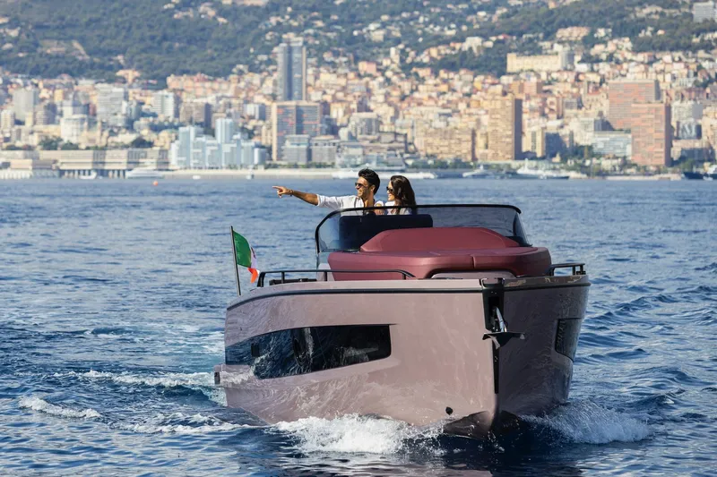 Slide: The Image of 2026 Cranchi A32 Luxury Tender cruising with cityscape backdrop. - 5