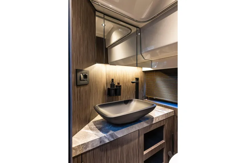 Slide: The Image of Luxurious bathroom interior of 2026 Cranchi A32 Luxury Tender with modern sink and wood accents. - 8