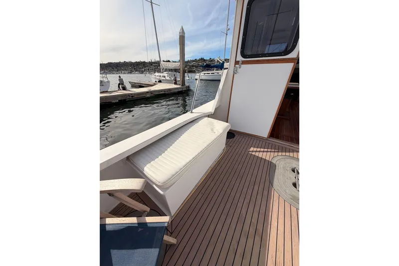 Slide: The Image of 2002 Eastern Downeast 35 boat deck with seating, docked at marina. - 11