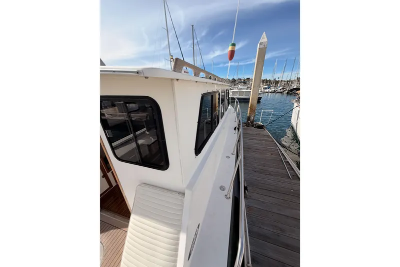 Slide: The Image of 2002 Eastern Downeast 35 boat docked at marina, side view with clear sky. - 14