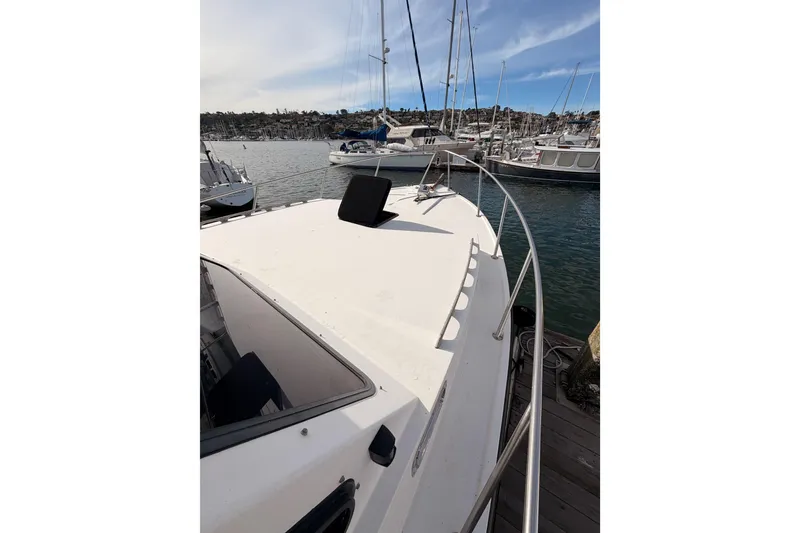 Slide: The Image of 2002 Eastern Downeast 35 boat docked in a marina with sailboats. - 16