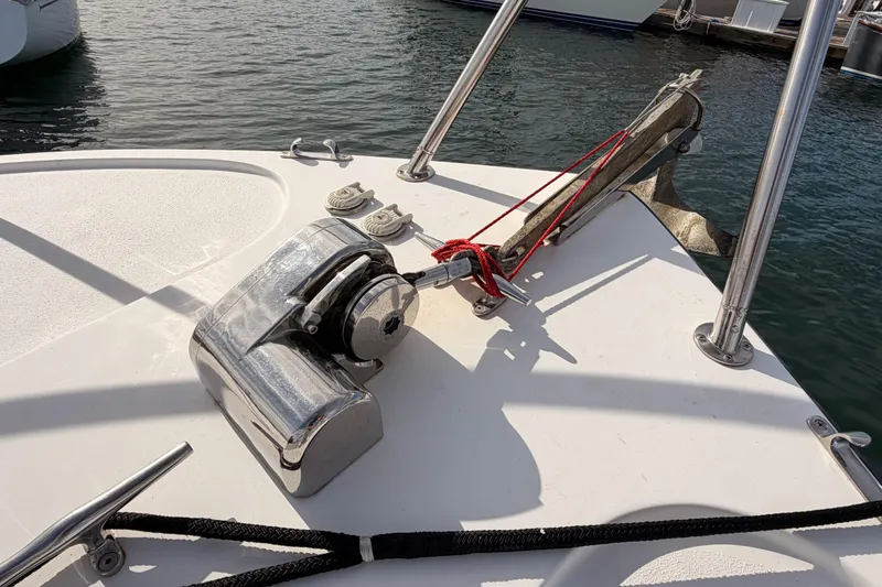 Slide: The Image of Anchor and winch on 2002 Eastern Downeast 35 boat deck by the water. - 18