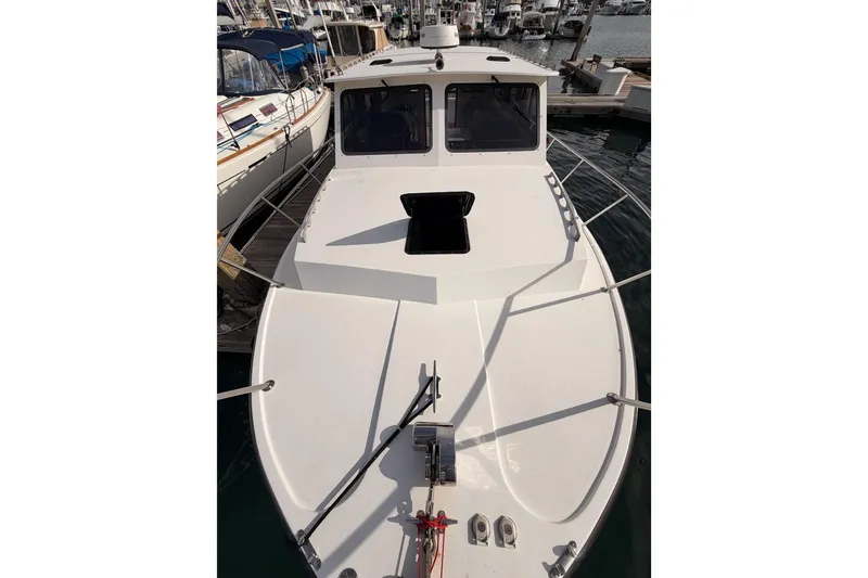 Slide: The Image of 2002 Eastern Downeast 35 boat docked in marina, top view of deck and cabin. - 19