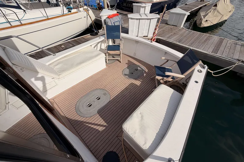 Slide: The Image of Spacious deck of 2002 Eastern Downeast 35 boat with seating and dock view. - 21