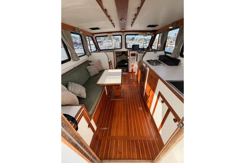 Slide: The Image of Interior of 2002 Eastern Downeast 35 boat with wood flooring and cozy seating area. - 22