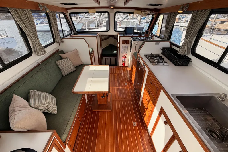 Slide: The Image of Interior of a 2002 Eastern Downeast 35 boat with wood flooring and kitchenette. - 23