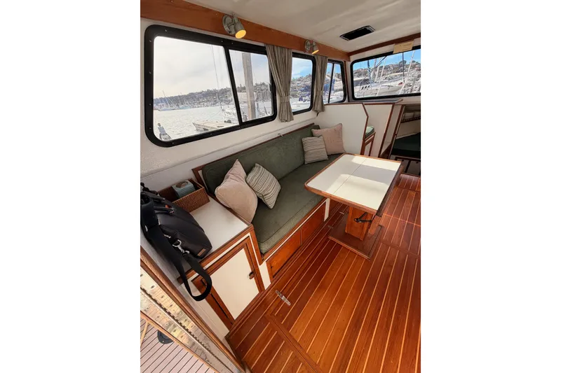 Slide: The Image of Interior of 2002 Eastern Downeast 35 boat with wooden flooring and cozy seating area. - 24