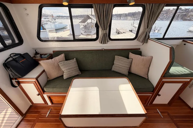 Slide: The Image of Interior of 2002 Eastern Downeast 35 boat with green seating and wooden accents. - 27