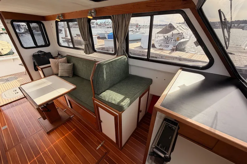 Slide: The Image of Interior of 2002 Eastern Downeast 35 boat with wood flooring and green seating. - 29