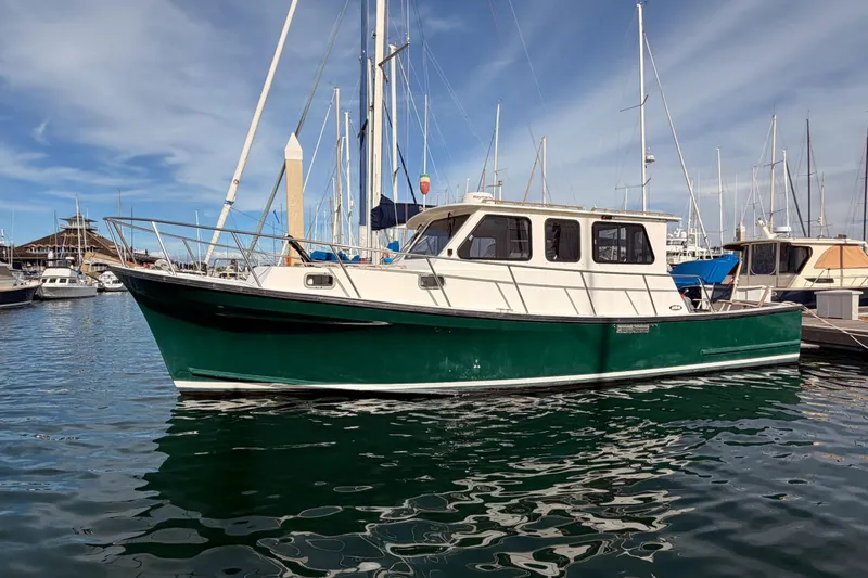 Slide: The Image of 2002 Eastern Downeast 35 boat docked in a marina under a clear blue sky. - 3