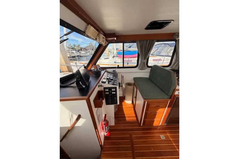 Slide: The Image of Interior of 2002 Eastern Downeast 35 boat with helm, seating, and wooden flooring. - 30